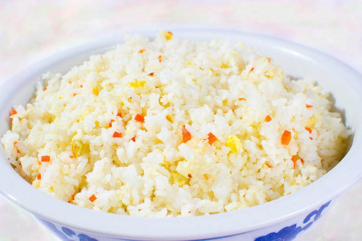 bowl of garlic rice with carrots and eggs fried in butter.